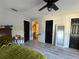 Bedroom featuring wood-look floors, black doors, and a view into the bathroom at 6113 Freeport Dr, Spring Hill, FL 34606