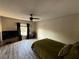 Bedroom featuring wood-look floors, a ceiling fan, a large window, and neutral walls at 6113 Freeport Dr, Spring Hill, FL 34606