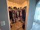 Walk-in closet with plenty of shelving, laminate floor, and hanging space at 6113 Freeport Dr, Spring Hill, FL 34606