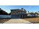 Beautiful exterior of a two-story home featuring arched windows, a well-kept lawn, and an attached garage at 6113 Freeport Dr, Spring Hill, FL 34606