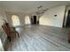 Open-concept living room featuring gray floors, light walls, and lots of natural light at 6113 Freeport Dr, Spring Hill, FL 34606