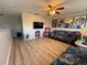 Bright loft area with wood flooring, comfortable seating, and unique artwork at 6113 Freeport Dr, Spring Hill, FL 34606