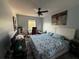 Comfortable main bedroom features a ceiling fan, large bed, and sunny window at 6113 Freeport Dr, Spring Hill, FL 34606