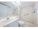 This all-white bathroom features tile and accessibility features in the shower and updated sink and lighting at 6171 Bahia Del Mar Blvd # 116, St Petersburg, FL 33715