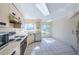 An open concept kitchen featuring neutral cabinetry and a large window for natural light at 6171 Bahia Del Mar Blvd # 116, St Petersburg, FL 33715