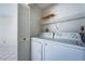 This laundry room has a side-by-side washer and dryer plus wire shelving at 6171 Bahia Del Mar Blvd # 116, St Petersburg, FL 33715