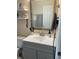 The bathroom features a vanity with shaker-style cabinets, a white countertop, and a framed mirror at 6483 43Rd N Ave, Kenneth City, FL 33709