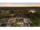 An aerial view of single-Gathering homes features screened-in pools and professional landscaping at twilight at 706 Acacia Ct, Bradenton, FL 34212