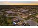 Aerial view of a neighborhood with houses surrounding a lake and mature trees at 706 Acacia Ct, Bradenton, FL 34212