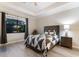 Cozy bedroom with a ceiling fan, patterned quilt, and a view of the backyard at 706 Acacia Ct, Bradenton, FL 34212