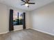 Spacious empty bedroom with wood floor, ceiling fan, and large window at 706 Acacia Ct, Bradenton, FL 34212