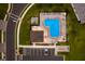 Aerial view of a community swimming pool, surrounding parking, and well-manicured lawns at 706 Acacia Ct, Bradenton, FL 34212