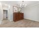 Elegant dining room featuring stylish wood floors, a decorative chandelier, and a wooden cabinet at 706 Acacia Ct, Bradenton, FL 34212