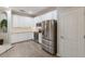 Well-lit kitchen with stainless steel refrigerator and white cabinets at 706 Acacia Ct, Bradenton, FL 34212