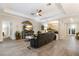 Welcoming living room with a TV, ceiling fan, and an arched entryway at 706 Acacia Ct, Bradenton, FL 34212