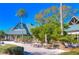 Relaxing outdoor patio area with tables, umbrellas, and lush landscaping at 7309 Night Heron Dr, Land O Lakes, FL 34637