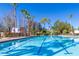 Inviting community lap pool with ample lounge chairs and shade structures at 7309 Night Heron Dr, Land O Lakes, FL 34637