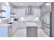 Modern kitchen with white cabinets, marble countertops, and stainless steel appliances at 7309 Night Heron Dr, Land O Lakes, FL 34637