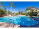 Community pool with palm trees and lounge chairs at 7309 Night Heron Dr, Land O Lakes, FL 34637