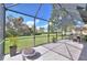 Large screened patio with fire pit and backyard view at 7309 Night Heron Dr, Land O Lakes, FL 34637