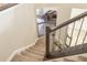 Modern staircase with dark wood railing and neutral carpeting at 7309 Night Heron Dr, Land O Lakes, FL 34637