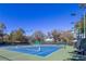 Well-lit tennis courts with blue surface at 7309 Night Heron Dr, Land O Lakes, FL 34637