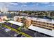 Aerial view of condos along a canal, showing parking, docks, and surrounding neighborhood at 7465 Bay Island S Dr # 115, South Pasadena, FL 33707