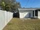 Backyard features a white privacy fence and access to the home through a door and screened patio at 7998 115Th St, Seminole, FL 33772