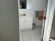 Bathroom features a white vanity with storage, a mirror, and coordinating towel set at 7998 115Th St, Seminole, FL 33772