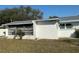 Backyard exterior features a screened in porch and an window opening at 7998 115Th St, Seminole, FL 33772