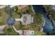 Aerial view of the property, showcasing a private pool and surrounding landscaping next to a pond at 8510 Kentucky Derby Dr, Odessa, FL 33556