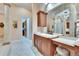 Bathroom vanity area featuring a marble countertop and a view into the walk-in closet at 8510 Kentucky Derby Dr, Odessa, FL 33556