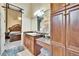 Bathroom featuring a granite vanity and adjacent bedroom with a distinctive wooden bedframe at 8510 Kentucky Derby Dr, Odessa, FL 33556