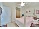 Cozy bedroom features a white four-poster bed, plush pink blanket, and neutral walls at 8510 Kentucky Derby Dr, Odessa, FL 33556