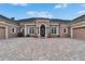 Beautiful home boasting an expansive brick driveway leading to the front entrance, featuring a three-car garage at 8510 Kentucky Derby Dr, Odessa, FL 33556