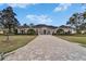 Stunning exterior view showcasing the home's architecture and paver driveway at 8510 Kentucky Derby Dr, Odessa, FL 33556