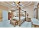 Spacious main bedroom featuring a four poster bed, decorative ceiling, and neutral color palette at 8510 Kentucky Derby Dr, Odessa, FL 33556