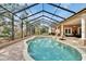 Beautifully screened pool and spa surrounded by lush landscaping and a spacious patio area at 8510 Kentucky Derby Dr, Odessa, FL 33556