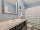 Bathroom featuring a vanity with granite countertop, framed mirror, shower and toilet at 8617 Falling Blue Pl, Riverview, FL 33578