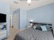 Bedroom featuring carpet flooring, a bed with decorative pillows and a tv stand at 8617 Falling Blue Pl, Riverview, FL 33578