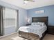 Bedroom featuring a decorative bed, carpet flooring, nightstands and large windows at 8617 Falling Blue Pl, Riverview, FL 33578