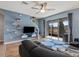 Inviting living room with a comfortable sofa, floating shelves, a ceiling fan, and a view of the screened patio at 8617 Falling Blue Pl, Riverview, FL 33578