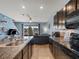 Cozy living room flowing into a modern kitchen, featuring a ceiling fan and a sliding glass door at 8617 Falling Blue Pl, Riverview, FL 33578