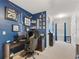 Office with carpet flooring, a desk, gaming chair, sports memorabilia and lots of wall decorations at 8617 Falling Blue Pl, Riverview, FL 33578