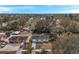 An aerial view displays this single-story home nestled in a quiet neighborhood with mature trees at 9013 Tree Valley Cir, Tampa, FL 33615