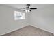 Cozy bedroom with a ceiling fan, carpet, and plenty of natural light at 9013 Tree Valley Cir, Tampa, FL 33615