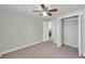 Tiled bedroom with closet and ceiling fan leading to bathroom at 9013 Tree Valley Cir, Tampa, FL 33615