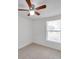 Bedroom with tiled floor, ceiling fan, and large window at 9013 Tree Valley Cir, Tampa, FL 33615