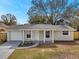 This lovely single-story home features well-manicured landscaping at 9013 Tree Valley Cir, Tampa, FL 33615