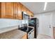 Kitchen featuring stainless steel appliances, granite countertops, and wooden cabinets at 9013 Tree Valley Cir, Tampa, FL 33615